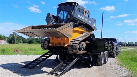 loading skid steer in back of dump trailer|skid steer trailer moving attachment.